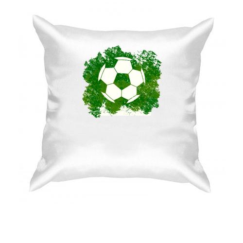 Подушка с футбольным мячом на фоне зелени